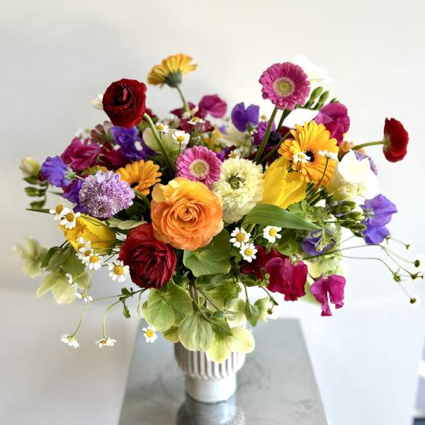 Colorful mixed bouquet in a white vase