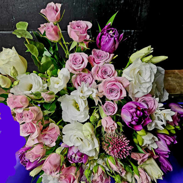 Bouquet of pink and white roses with purple blooms