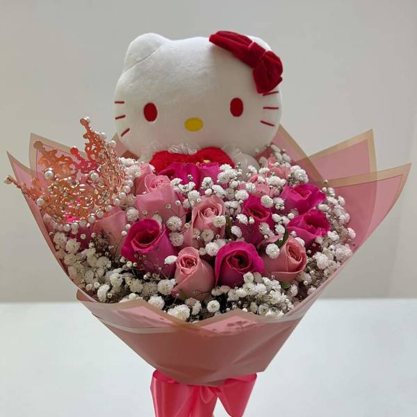 Hello Kitty plush with pink roses and baby's breath bouquet