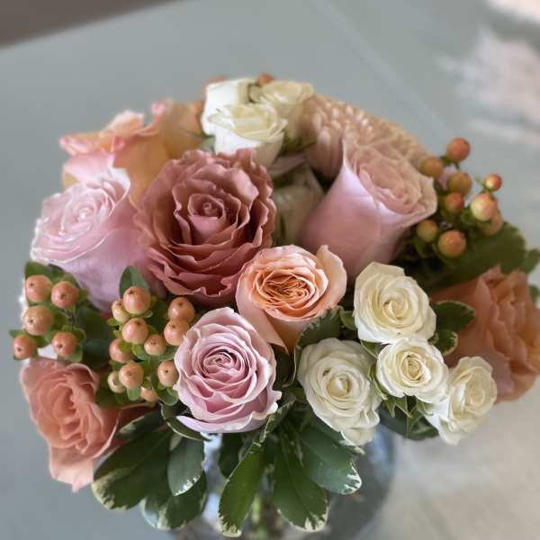 Bouquet of pink and white roses in a glass vase
