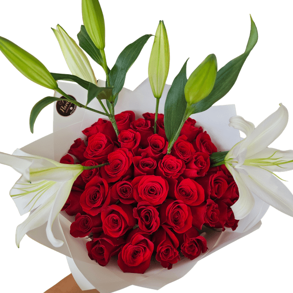 Bouquet of red roses with white lilies wrapped in white paper