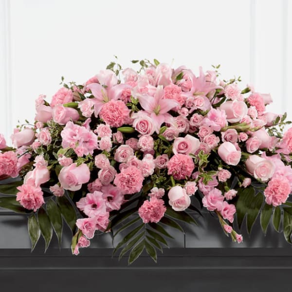 Large pink floral casket spray with roses and lilies