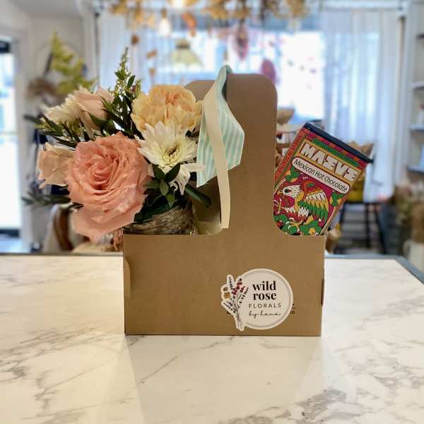 Floral gift box with pink and cream flowers and a hot chocolate packet