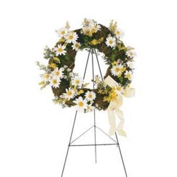 Daisy wreath on a standing easel with a cream ribbon