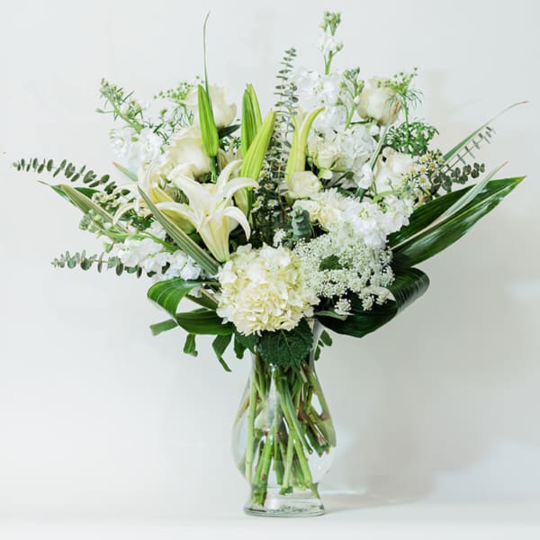 White floral arrangement in a clear glass vase