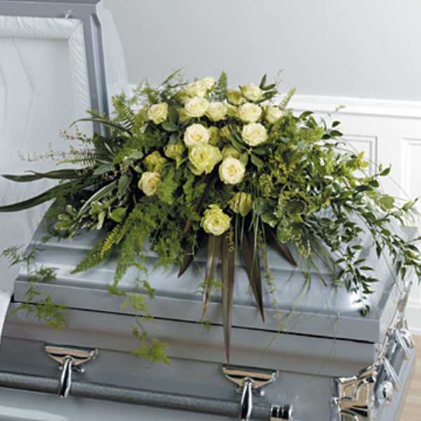 White rose casket spray with cascading greenery