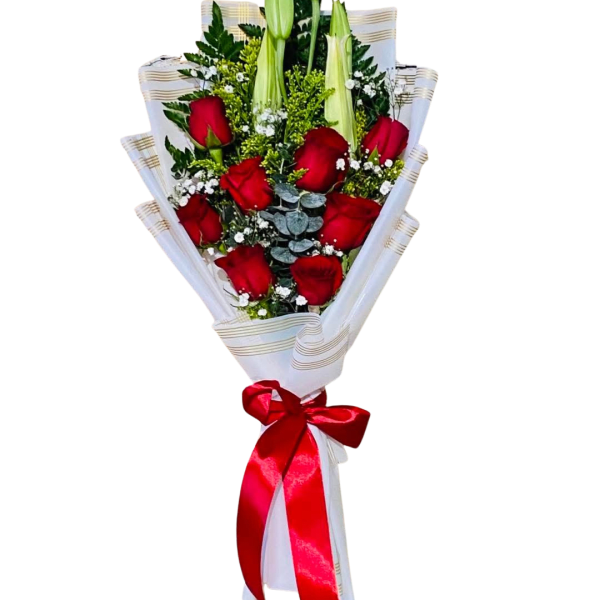 Bouquet of red roses and white lilies wrapped in white paper with a red ribbon