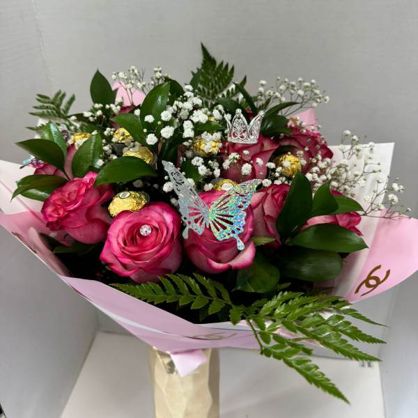 Pink rose bouquet with baby's breath, gold chocolates, and butterfly picks
