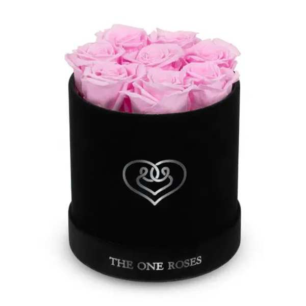 Pink roses arranged in a black round box