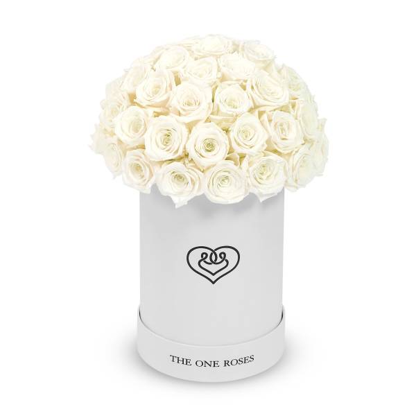 White roses arranged in a round white hat box