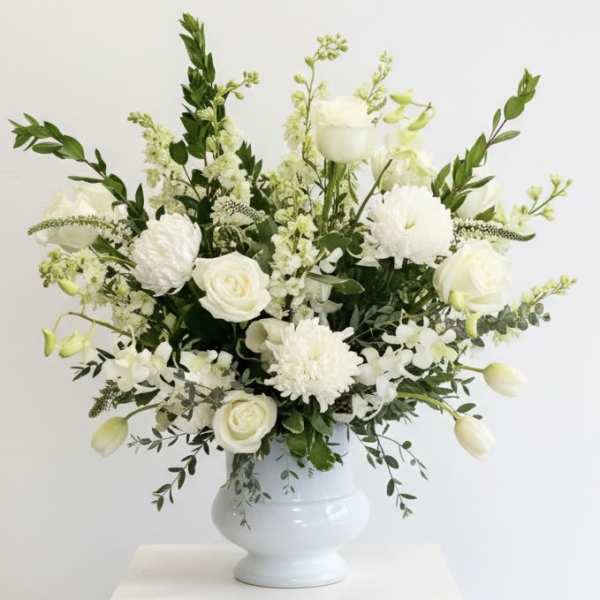 White floral arrangement in a white vase