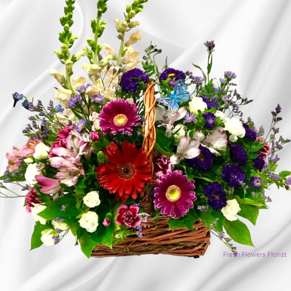 Mixed flower basket with gerbera daisies, alstroemeria, and purple blooms