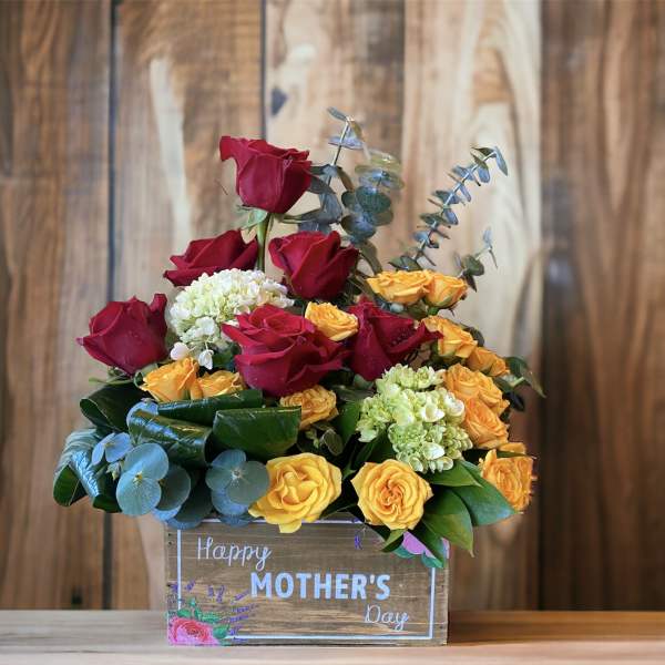 Mixed roses in a wooden box with a Happy Mother's Day sign