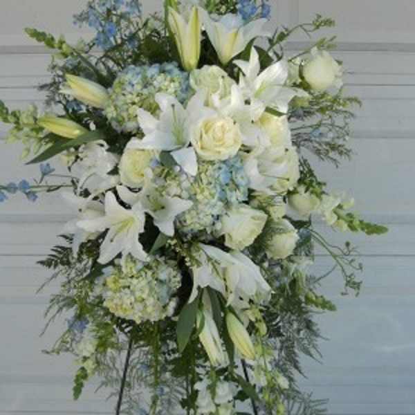 Tall white floral standing spray with lilies and roses