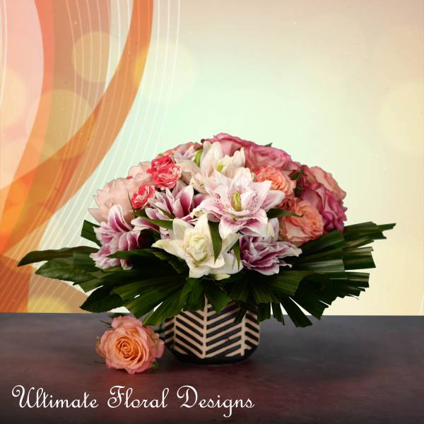 Pink and white flower arrangement in a patterned vase