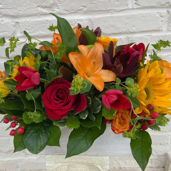 Colorful bouquet with roses, tulips, lilies, and a sunflower