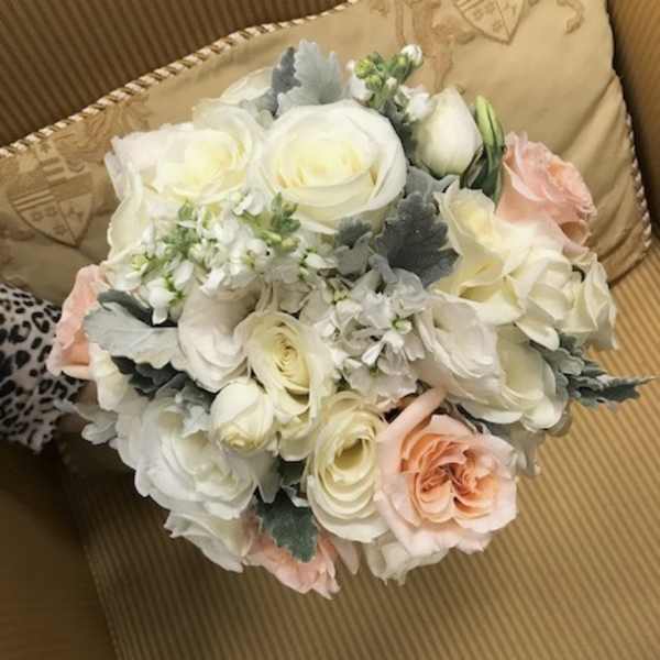 Bouquet of white and blush roses with pale filler flowers