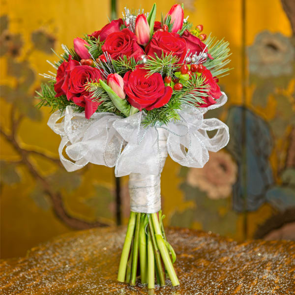 Red rose bouquet with white ribbon and greenery