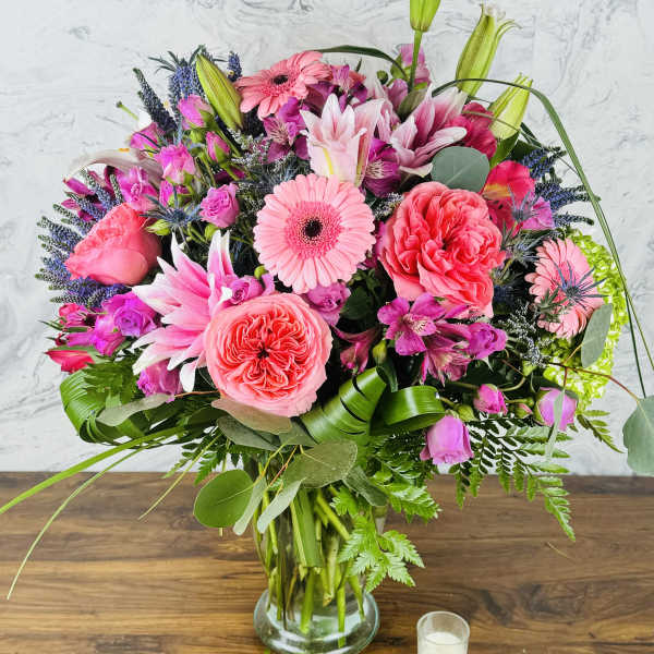 Pink and purple mixed bouquet in a glass vase