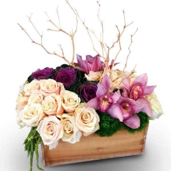 Mixed roses and pink orchids arranged in a wooden box