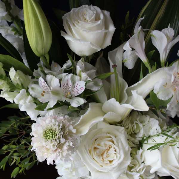 White floral bouquet with roses, lilies, and calla lilies