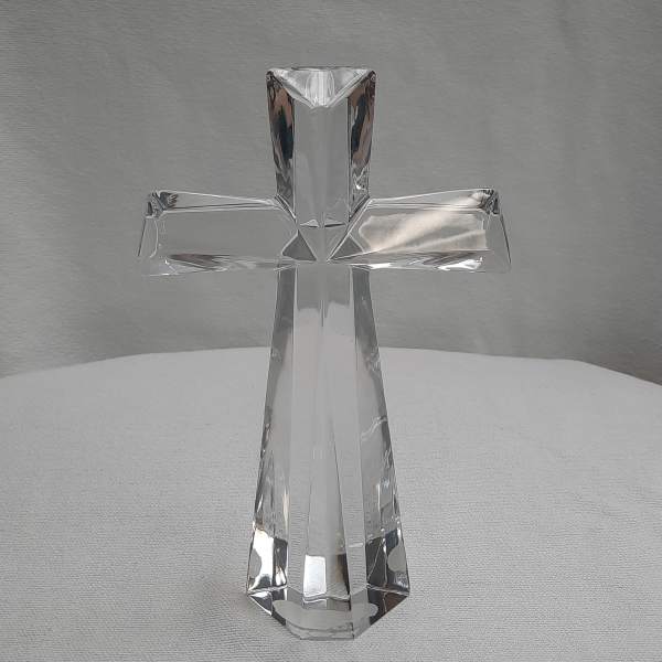 Clear glass cross figurine on a light surface