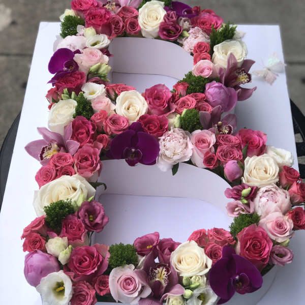Large floral letter arrangement with pink and white roses and orchids