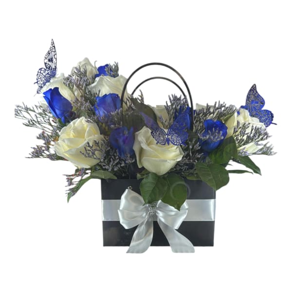 White and blue roses in a black gift bag with a silver bow