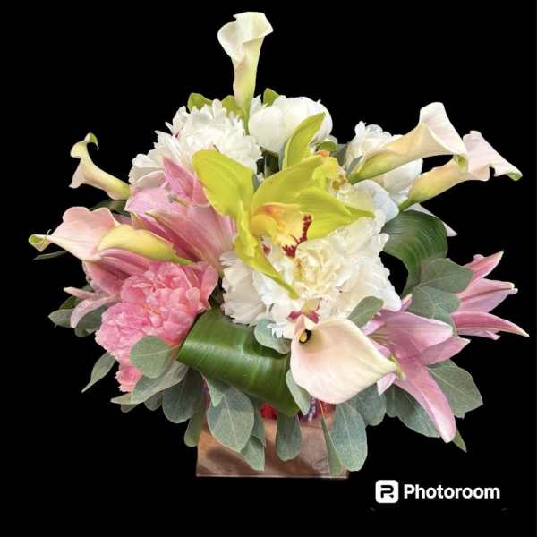 Bouquet of pink and white flowers with calla lilies in a box