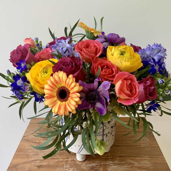 Colorful mixed bouquet in a white ceramic vase