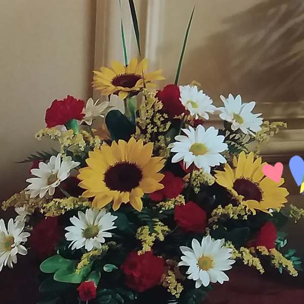 Large bouquet of sunflowers, daisies, and red roses