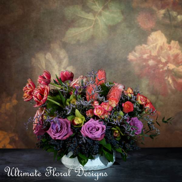 Mixed bouquet of roses and tulips in a white bowl vase
