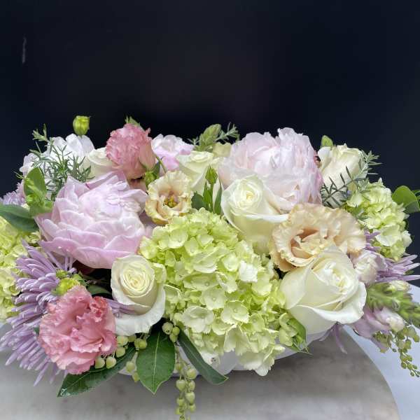 Pastel floral arrangement with roses, hydrangeas, and carnations