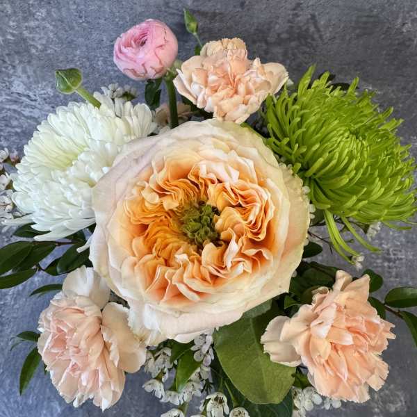 Bouquet of peach, pink, white, and green flowers