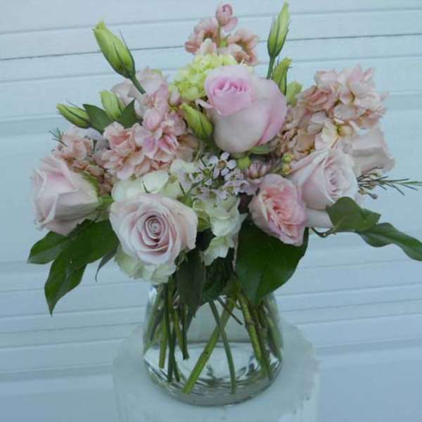 Pink and white flower bouquet in a clear glass vase