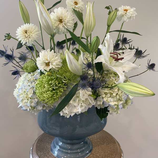 White lilies and mixed blooms in a blue vase