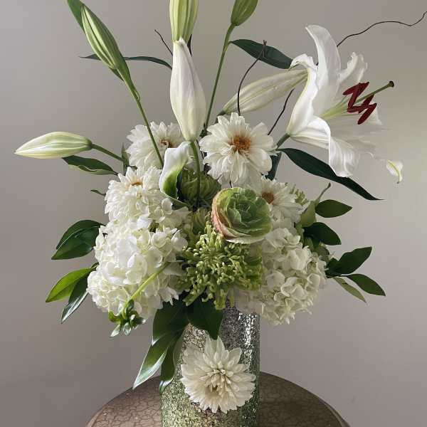 White lilies and hydrangeas in a glittered vase