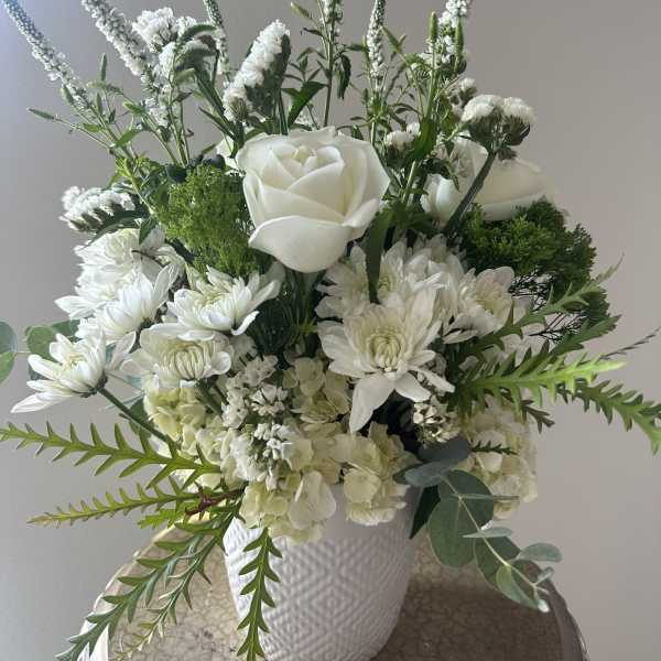 White floral arrangement in a textured white vase