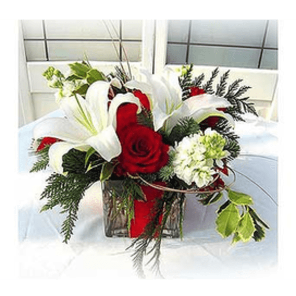 Red roses and white lilies arranged in a glass vase