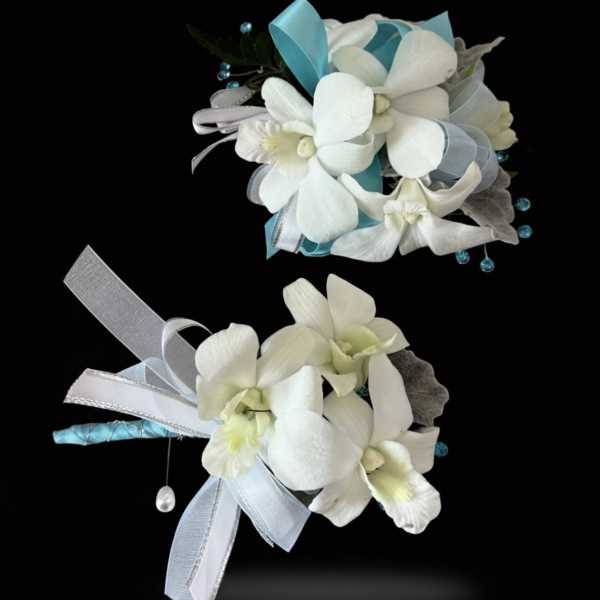 A matching set of white dendrobium orchid corsage and boutonniere set