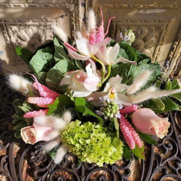 Bouquet of pale pink roses, white orchids, and green hydrangea