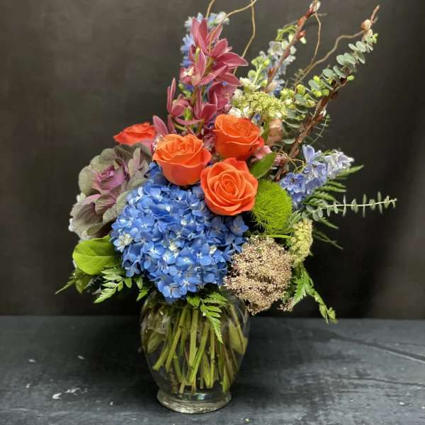 Colorful mixed flower arrangement in a glass vase