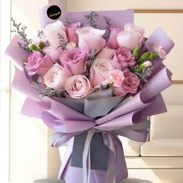Bouquet of pink and lavender roses wrapped in purple paper