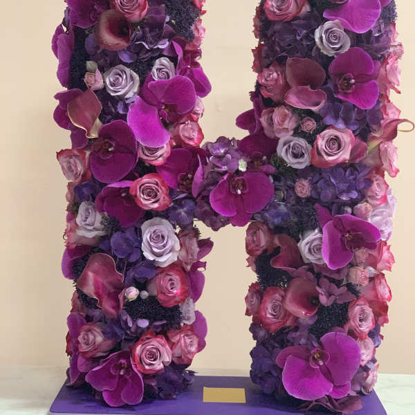Large floral letter H covered in pink, purple, and lavender blooms