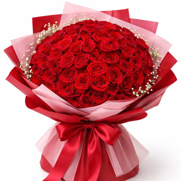 Large bouquet of red roses wrapped in pink and red paper with a ribbon