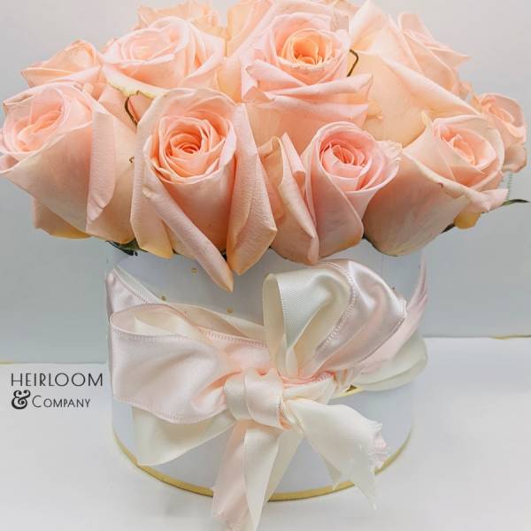 Bouquet of pale peach roses in a white hat box with a satin ribbon
