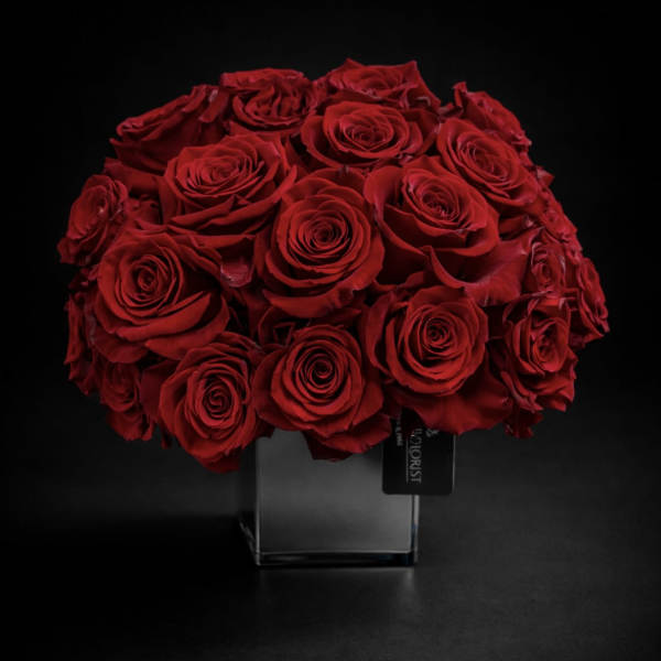 Bouquet of red roses in a clear square vase
