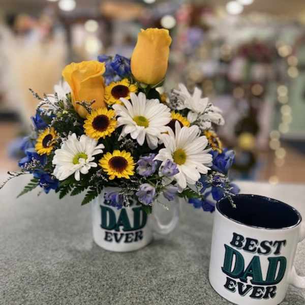 Bouquet of yellow roses, daisies, and blue flowers in a mug beside a matching Dad mug