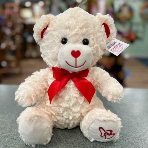 White teddy bear with a red bow and heart details