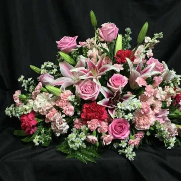 Pink roses and lilies arranged in a low bouquet